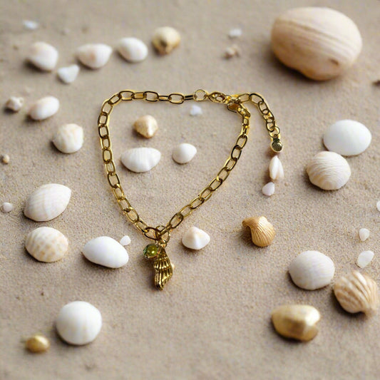 A gold-colored stainless steel waterproof bracelet with a shell-like pendant.